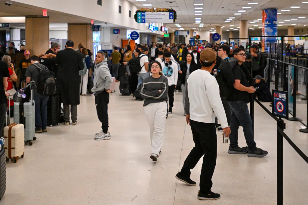 Passengers at Jose Aponte de la Torre Airport in Puerto Rico walk around the terminal after all flights were cancelled after the US military operation in Venezuela on Jan. 3, 2026.