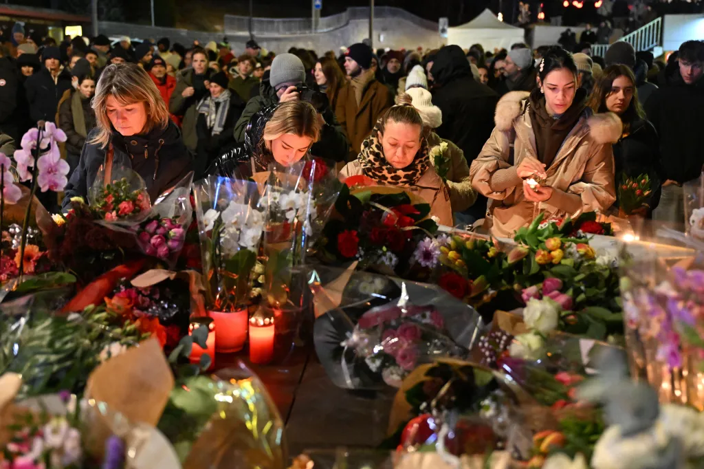 Mourners leaving flowers and candles at the scene of the fire in Crans-Montana, Switzerland.