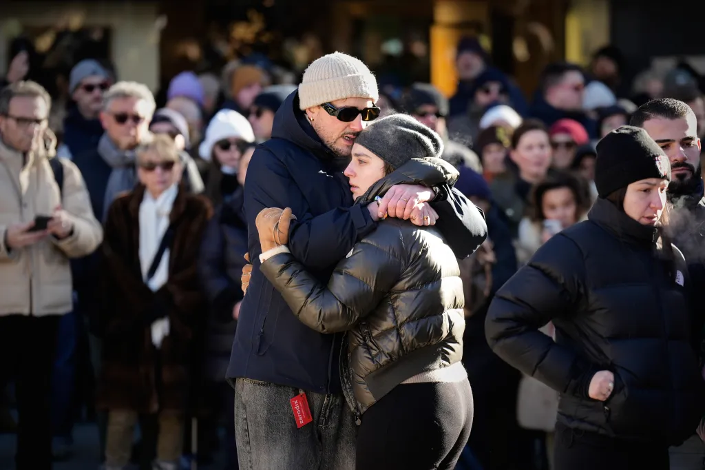 People cry during a memorial procession for the victims of the Le Constellation fire on Jan/ 4, 2026.