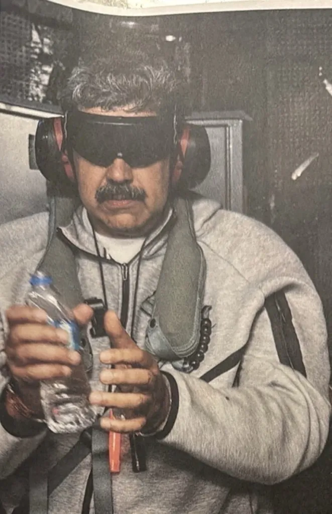 Venezuelan President Nicolas Maduro wearing blindfold-style eye protection and headphones, holding a water bottle.