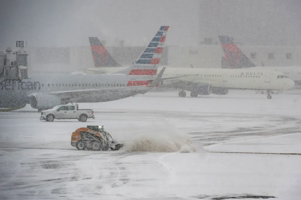 A snow plow working to clear snow from the tarmac at Boston's Logan Airport during Winter Storm Fern on Jan. 25, 2026