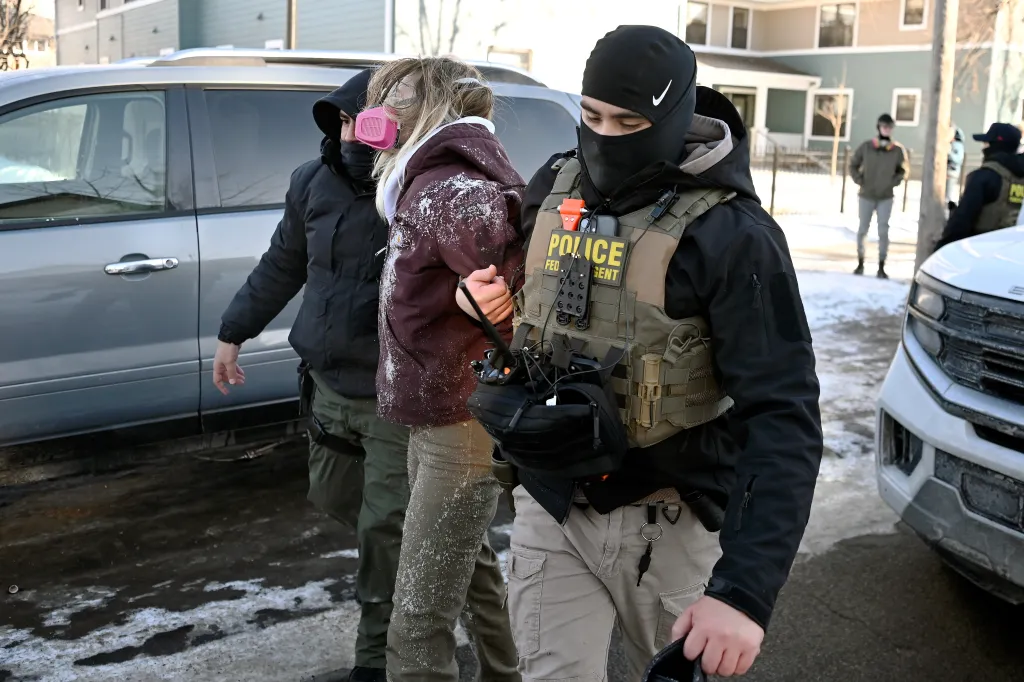 A federal agent detains a woman in Minneapolis, Minnesota, on Jan. 29, 2026.