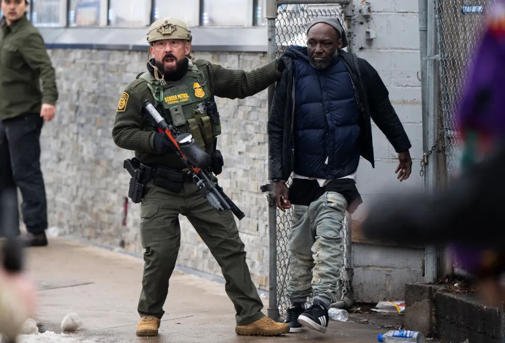 A Border Patrol agent arresting a man in Minneapolis.