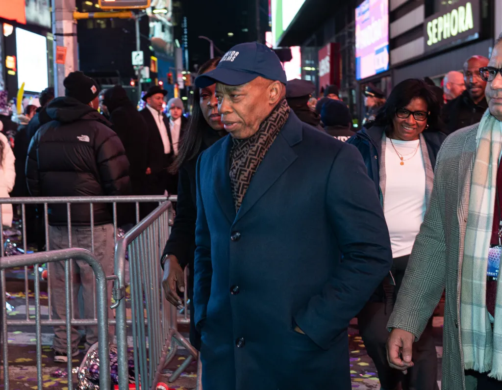 Outgoing New York City Mayor Eric Adams arrives in Times Square before midnight on Dec. 31, 2025.