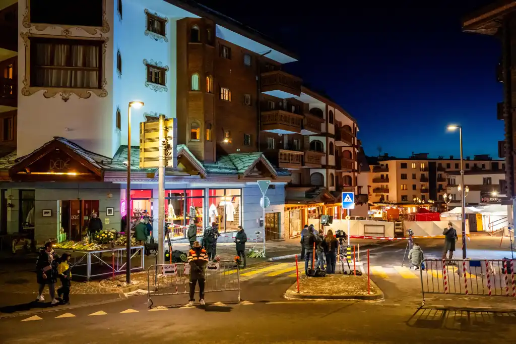 Journalists and emergency personnel outside a bar in Crans-Montana, Switzerland, where a fire occurred.