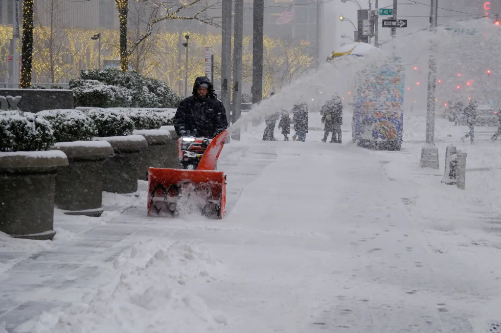 A worker clearing the sidewalk on Sixth Avenue near 47th Street in Manhattan.