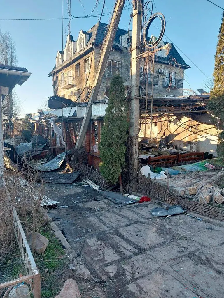 This handout photo released by Russia-appointed governor of the Kherson region, Vladimir Saldo, shows the site of a drone attack on a hotel in Khroly on January 1, 2026.