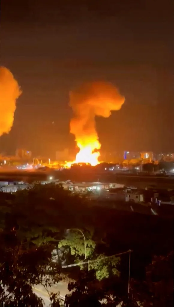 Smoke and fire rises from an explosion in Caracas, Venezuela, on Jan. 3, 2026.