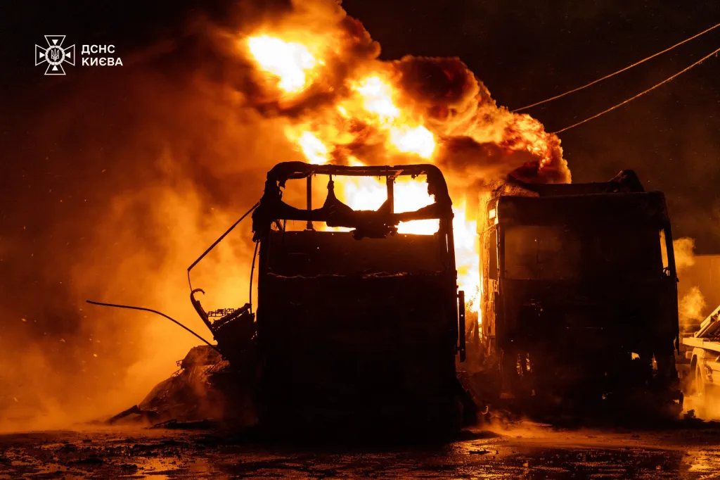 Trucks burn up after being struck during an air attack in Kyiv on January 24, 2026.