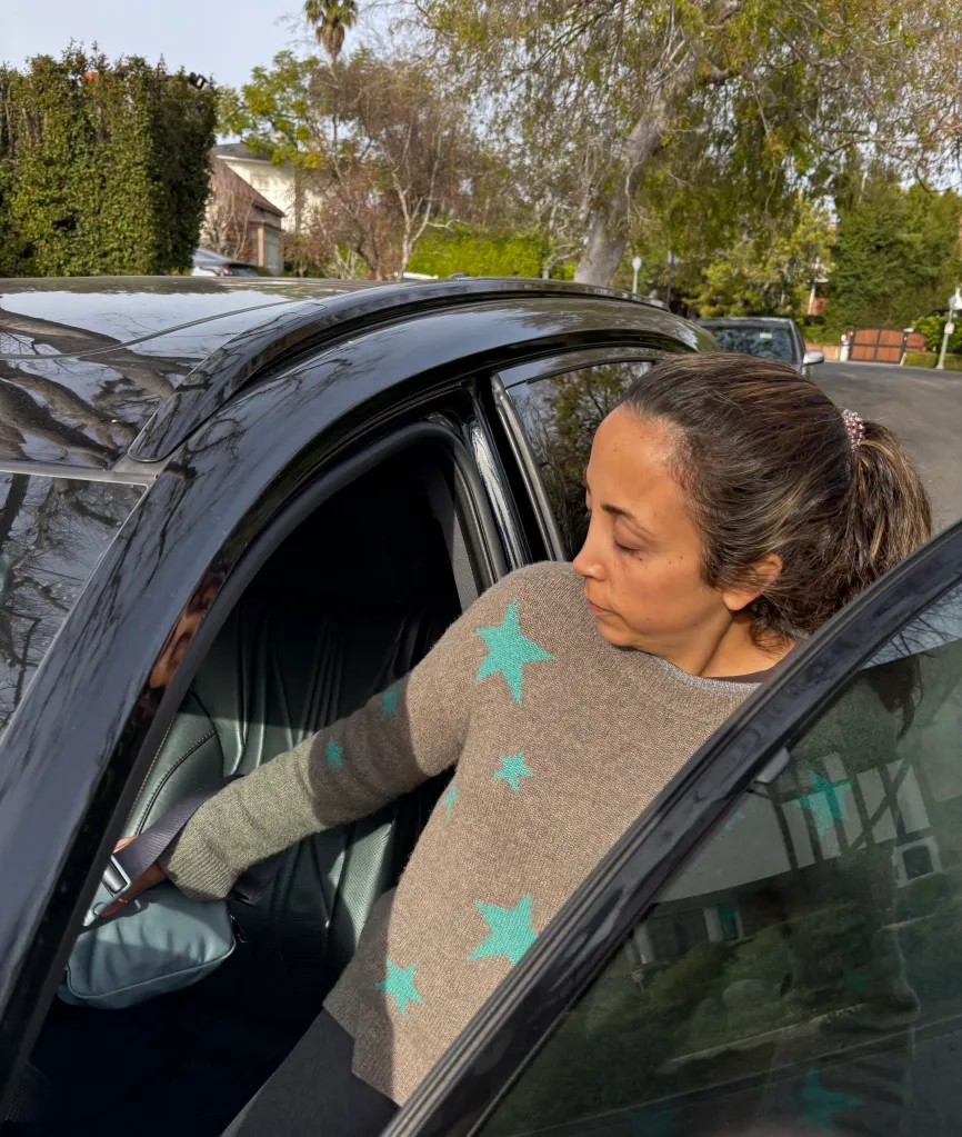 Ashley Aframian, wife of Alexander Soofer, getting into her car outside their home in Westwood, Los Angeles.