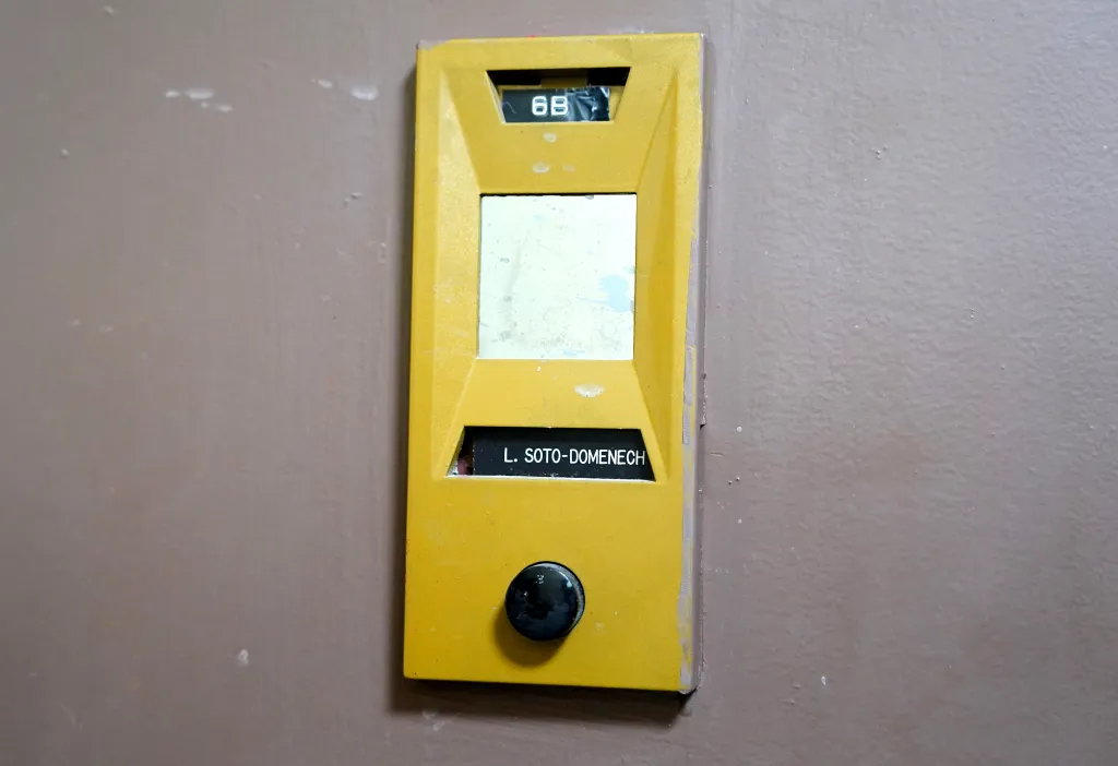 An apartment intercom labeled 