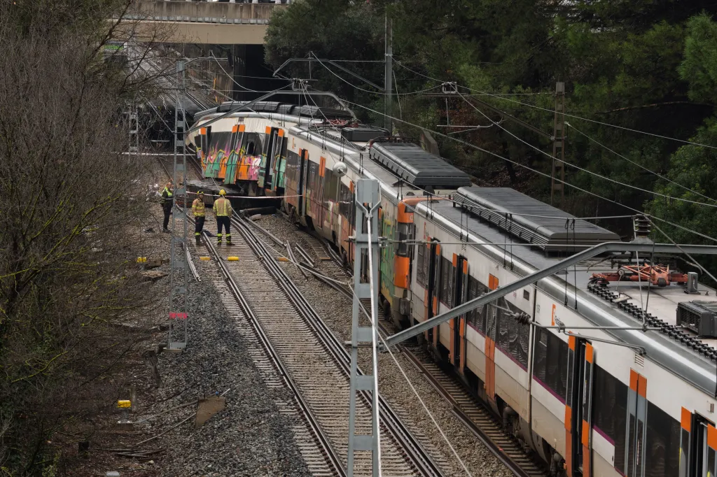 Train derailment in Gelida, Spain, with emergency personnel on site.