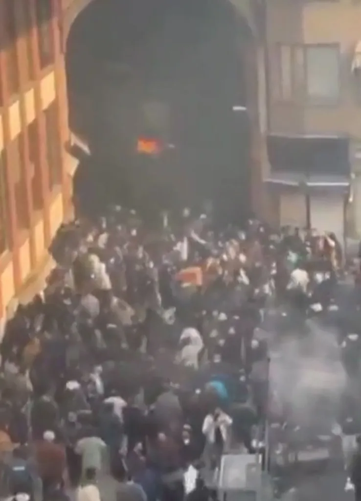 Protesters clashing with Iranian security forces at the Tehran bazaar.