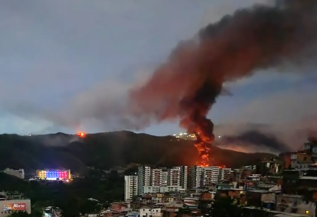 A fire erupts at Venezuela's Fuerte Tiuna military complex after the airstrikes.