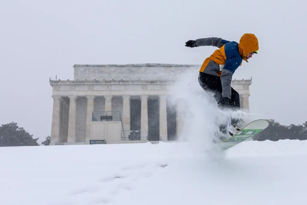 Jonnie Plass snowboarding on the stairs near the Lincoln Memorial during a winter storm in Washington, DC.