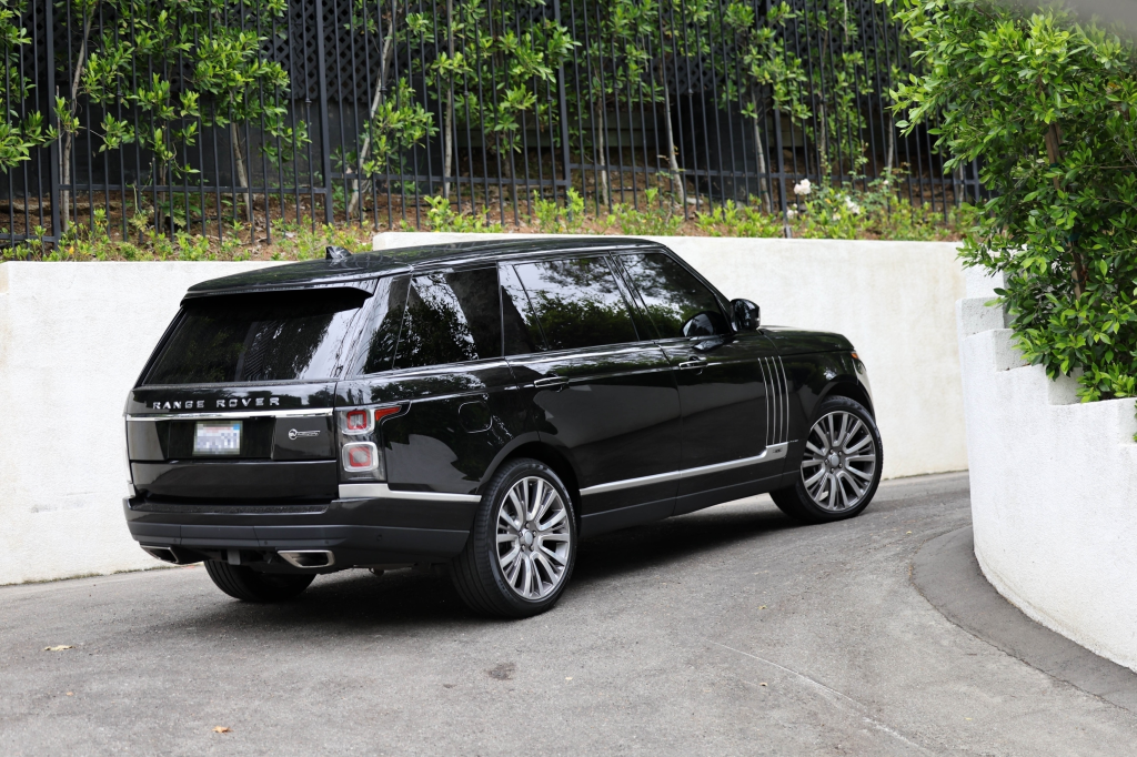 Kylie Jenner's black Range Rover drives down a residential street.