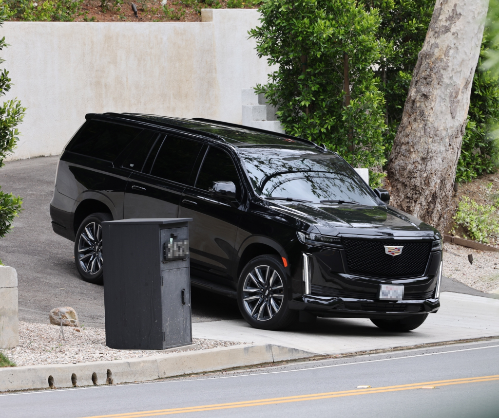 Kylie Jenner's black Cadillac Escalade parked in a driveway.
