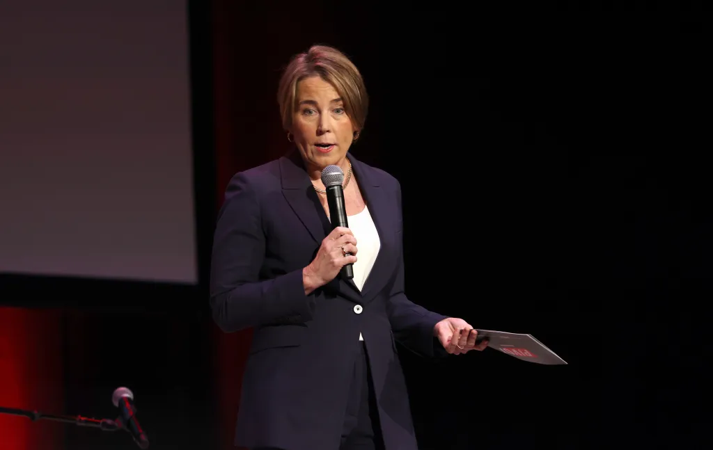 Kara Swisher holding a microphone on stage.