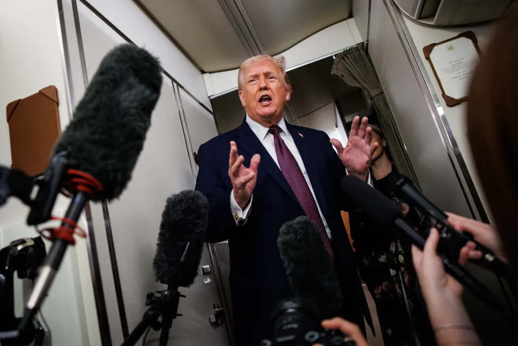 President Donald Trump takes questions from the members of the press aboard Air Force One en route back to the White House on January 11, 2026 in Palm Beach, Florida.