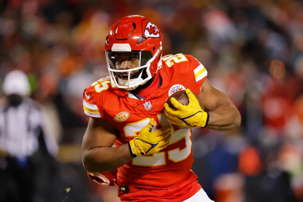Kansas City Chiefs player Clyde Edwards-Helaire running with the football.