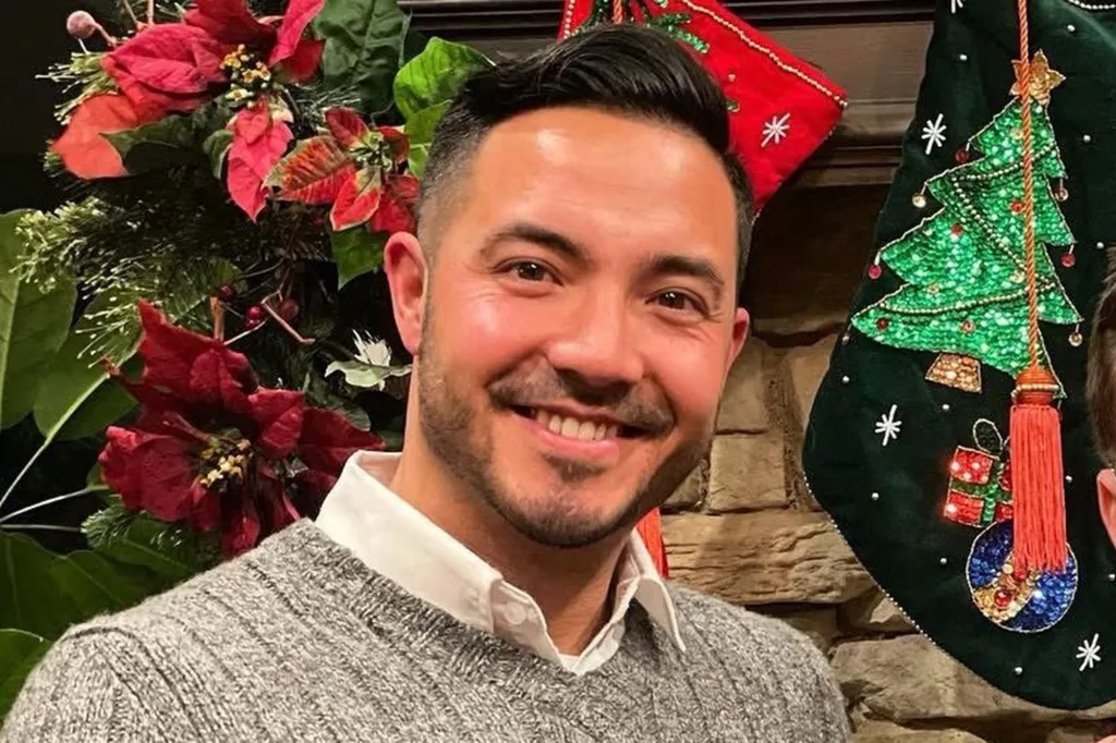 burke smiling in a sweater