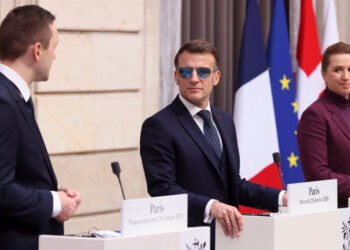 Sunglasses, and Stormy Times, Lift France’s Embattled Leader