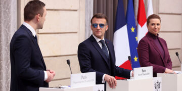 Sunglasses, and Stormy Times, Lift France’s Embattled Leader