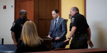 Husband Denies Plot in Double Murder Trial, Calling Accusations ‘Crazy’