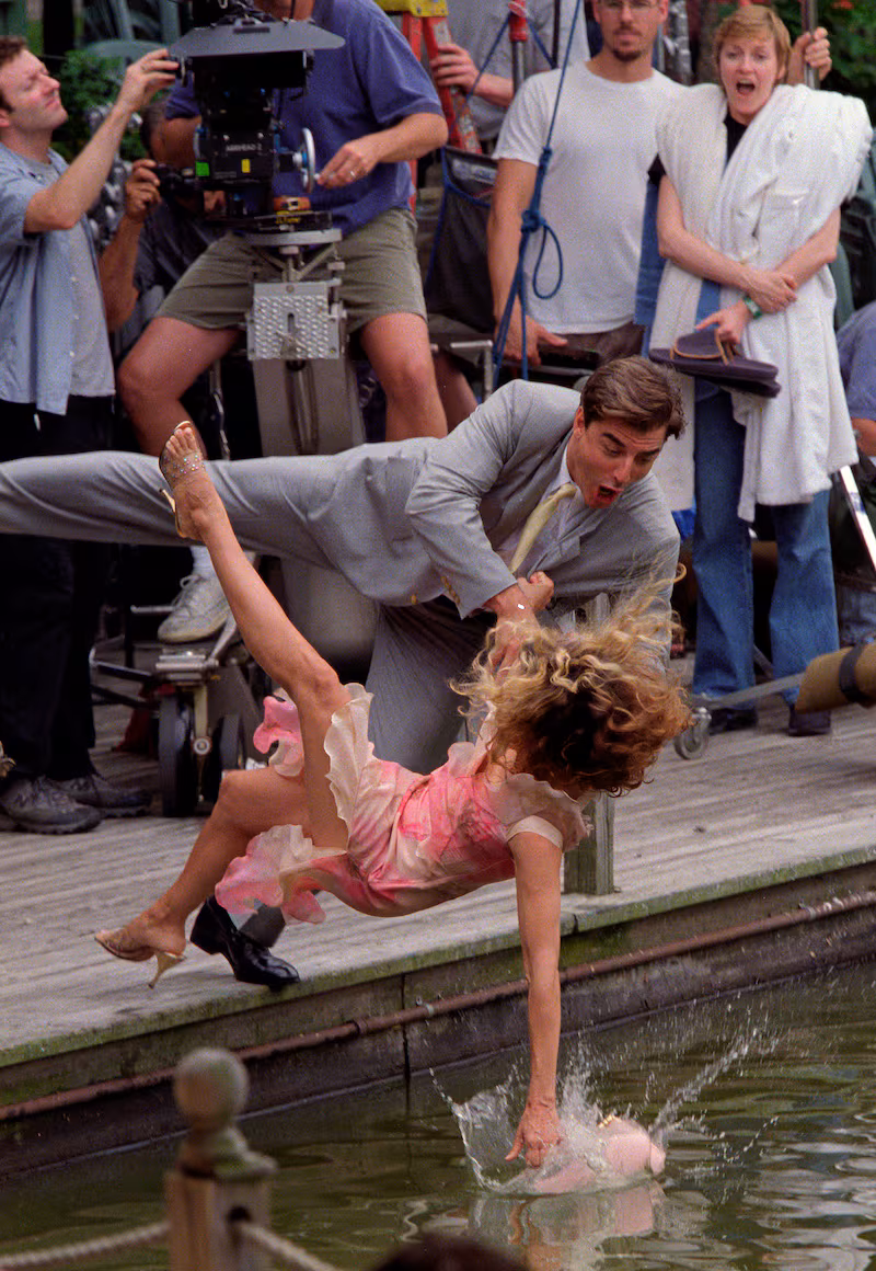 Sarah Jessica Parker, as Carrie Bradshaw, and Chris Noth, John James Preston or Mr. Big, fall into Central Park Lake filming a scene for Sex & the City, NYC July 24, 2000. Exclusive (Photo by Lawrence Schwartzwald/Sygma via Getty Images)