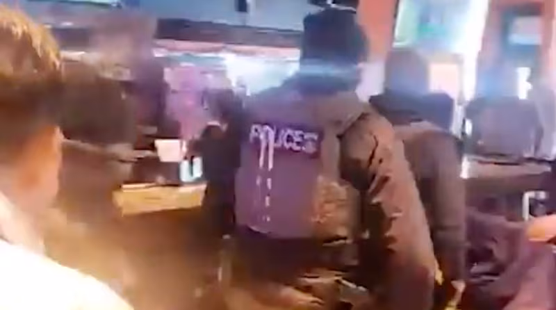 ICE agents are escorted out of Cancun Mexican Grill & Cantina.