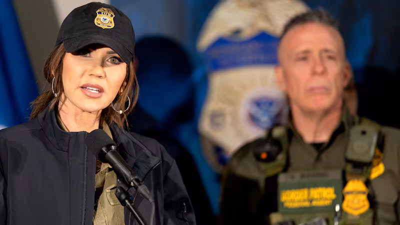 Secretary of Homeland Security Kristi Noem during a press conference at the Bishop Henry Whipple Federal Building in Minneapolis, Minn., on Wednesday, January 7, 2026. Behind Noem is Border Patrol official, Gregory Bovino.