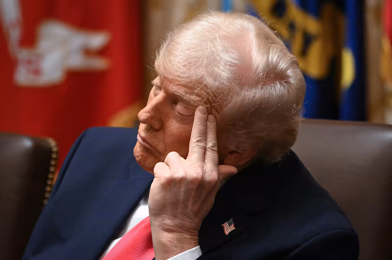 President Donald Trump looks on as members of his cabinet speak during a Cabinet Meeting in the Cabinet Room of the White House in Washington, DC on December 2, 2025.