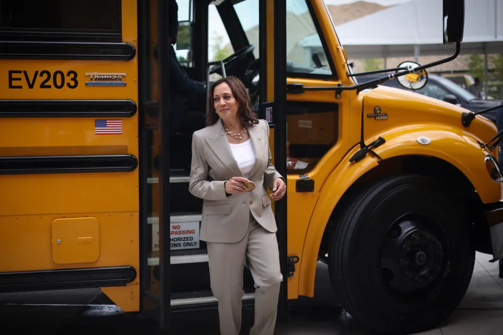 Vice President Kamala Harris stepping off a new electric school bus.