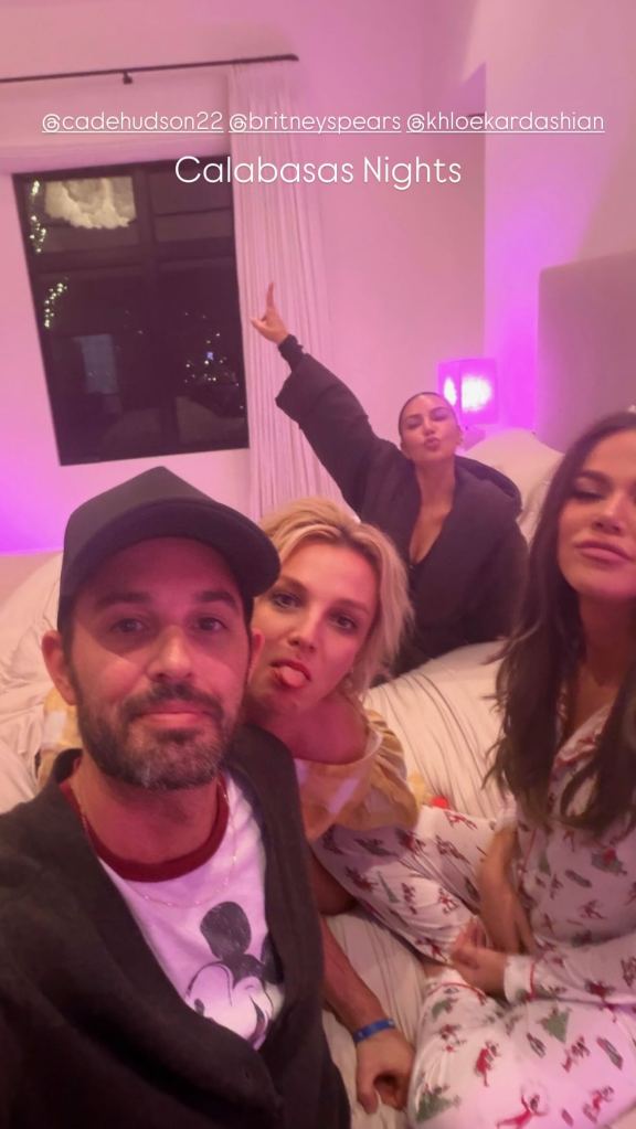 Cade Hudson takes a selfie with Britney Spears and Kim and Khloé Kardashian in a dimly lit room with pink lighting, text overlay 