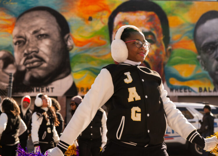 Hundreds march to celebrate MLK — and protest Trump