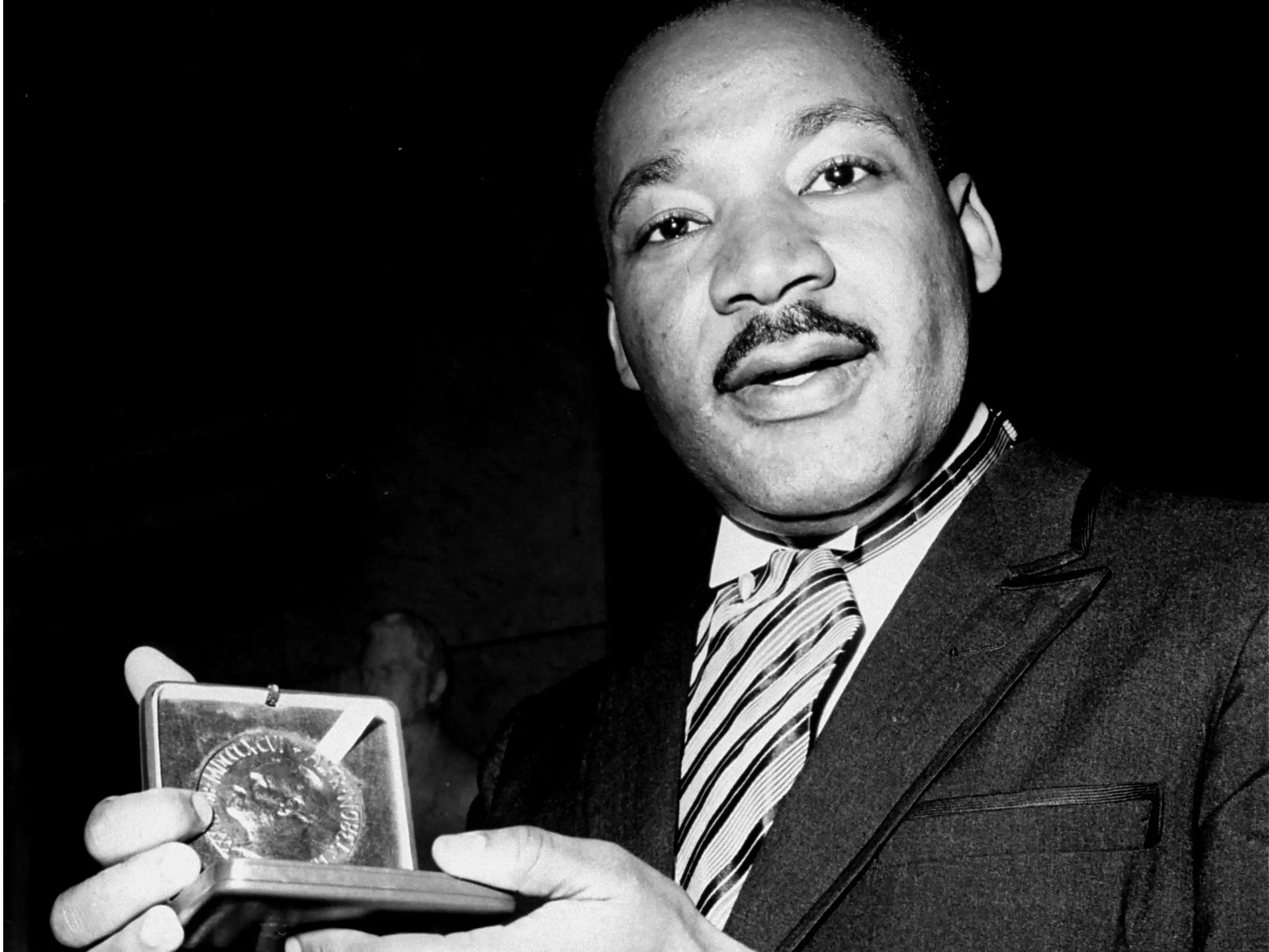 Martin Luther King Jr. holding his Nobel Peace Prize.