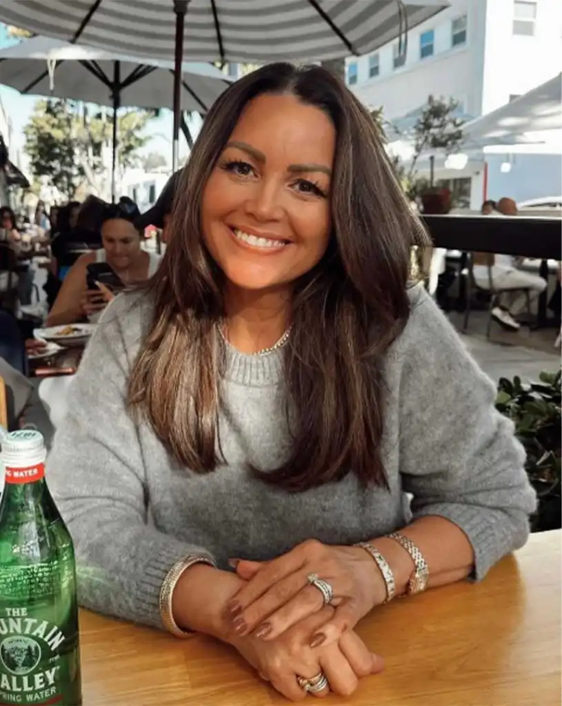 Shawna Collins, a staff member of Joel Osteen's Lakewood Church, smiling while seated at a table.