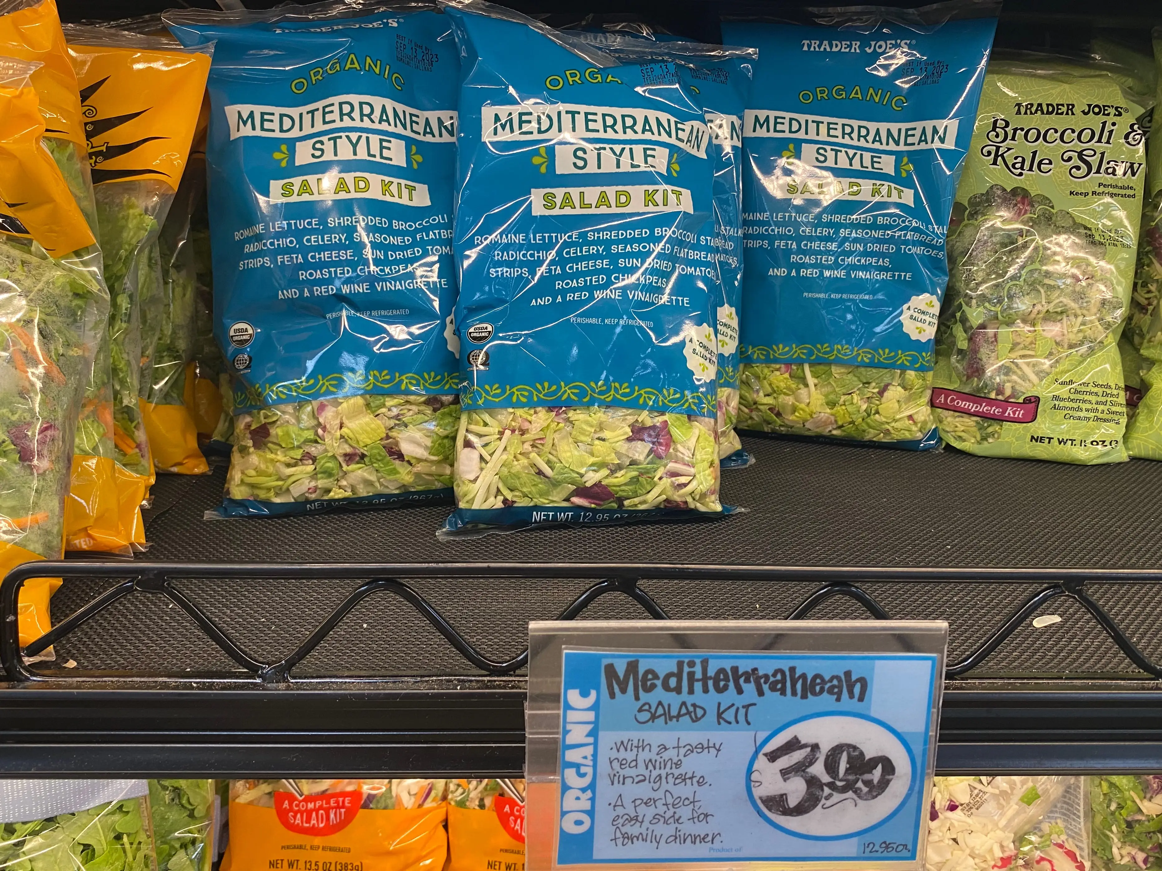 mediterranean style salad kit on the fridge shelf with salad kits at trader joes