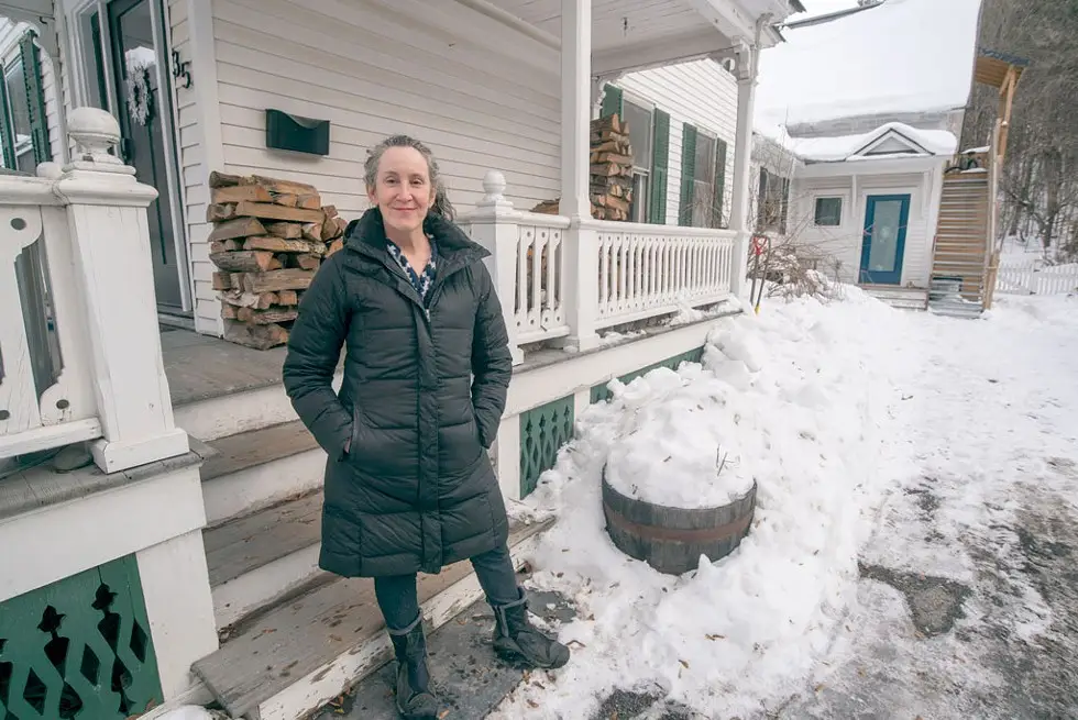 Marni Leiken in front of herm Vermont home.