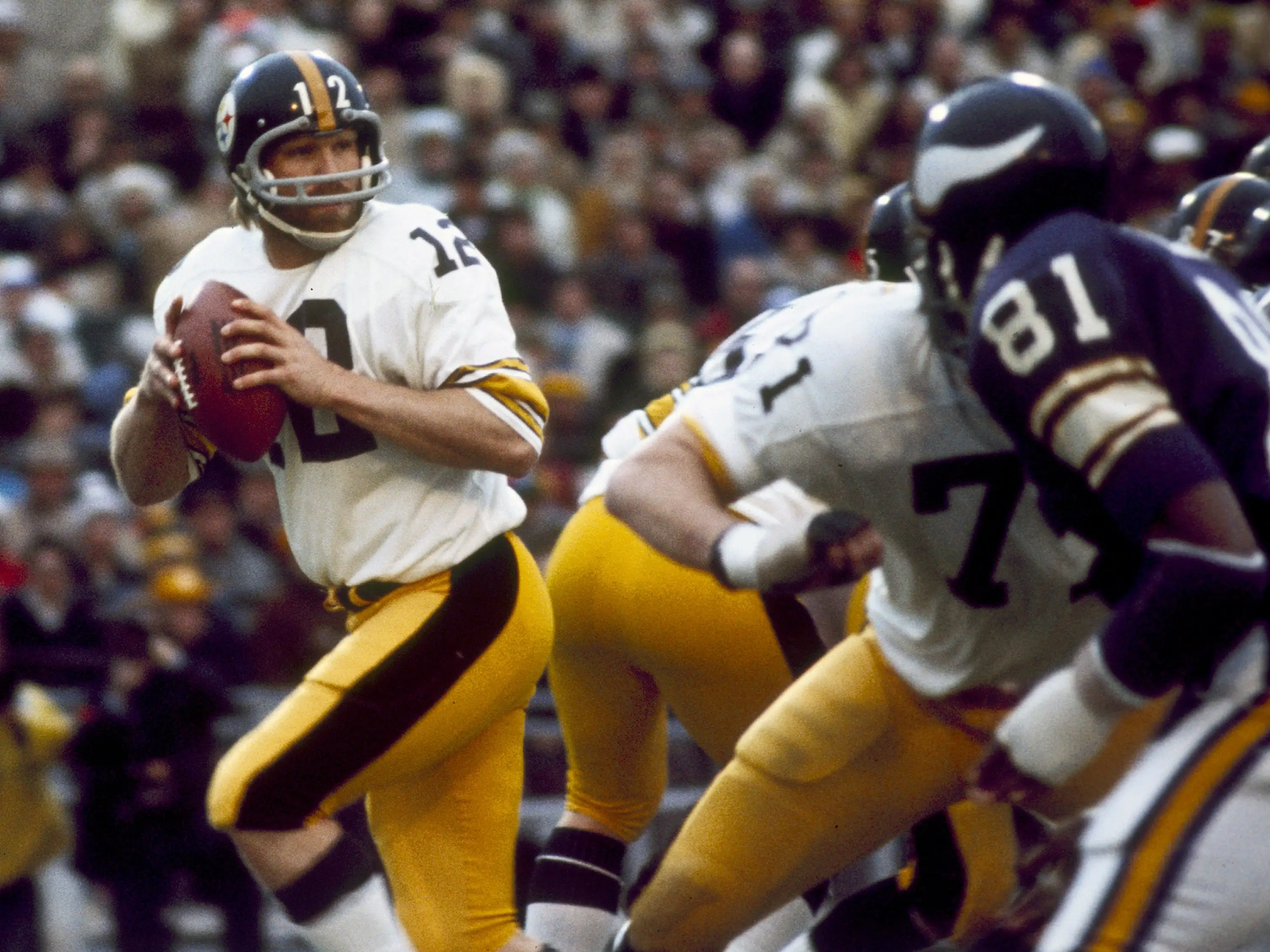 Terry Bradshaw prepares to pass the football in Super Bowl IX.