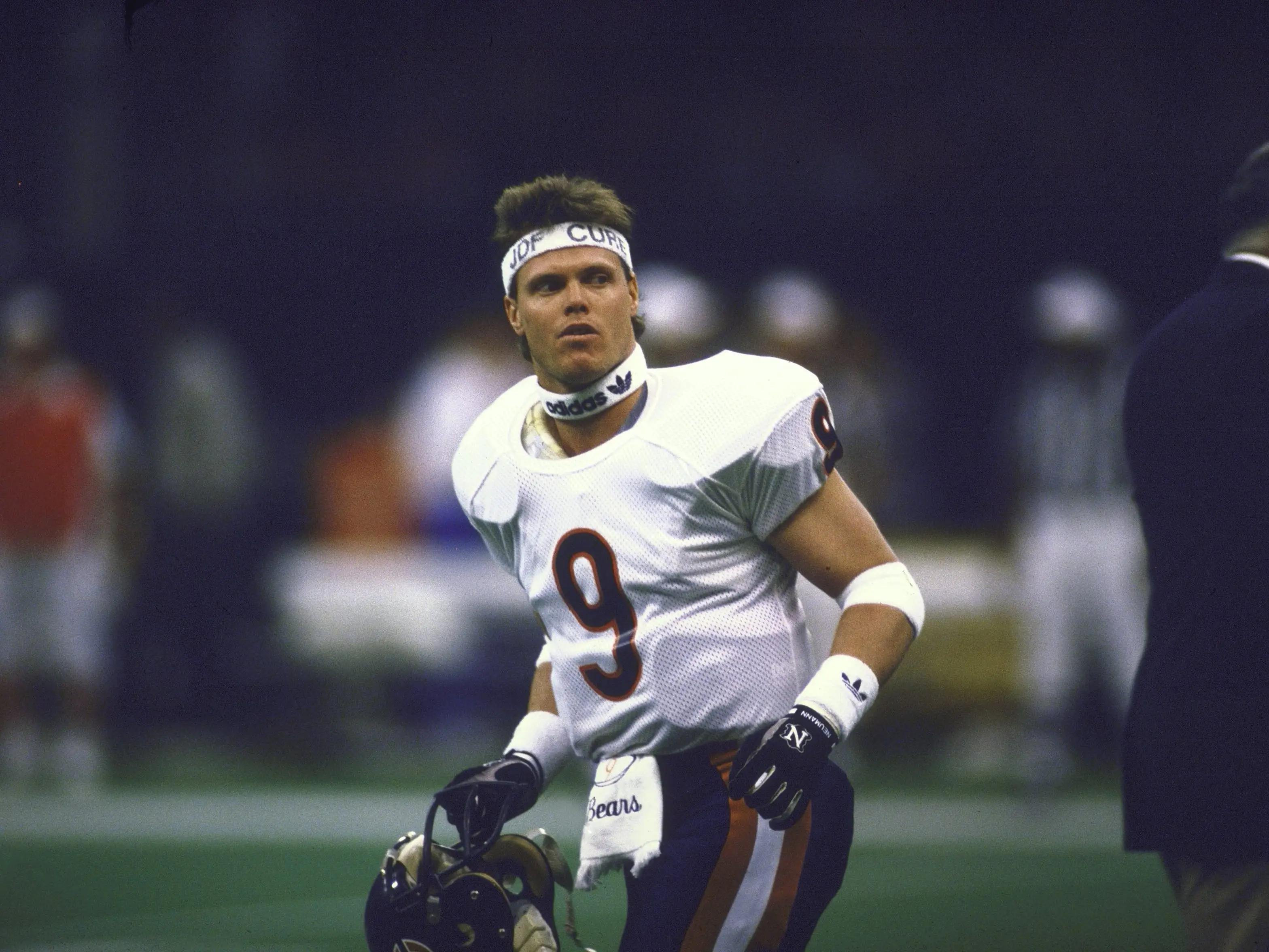 Jim McMahon running on the sideline with his helmet off.