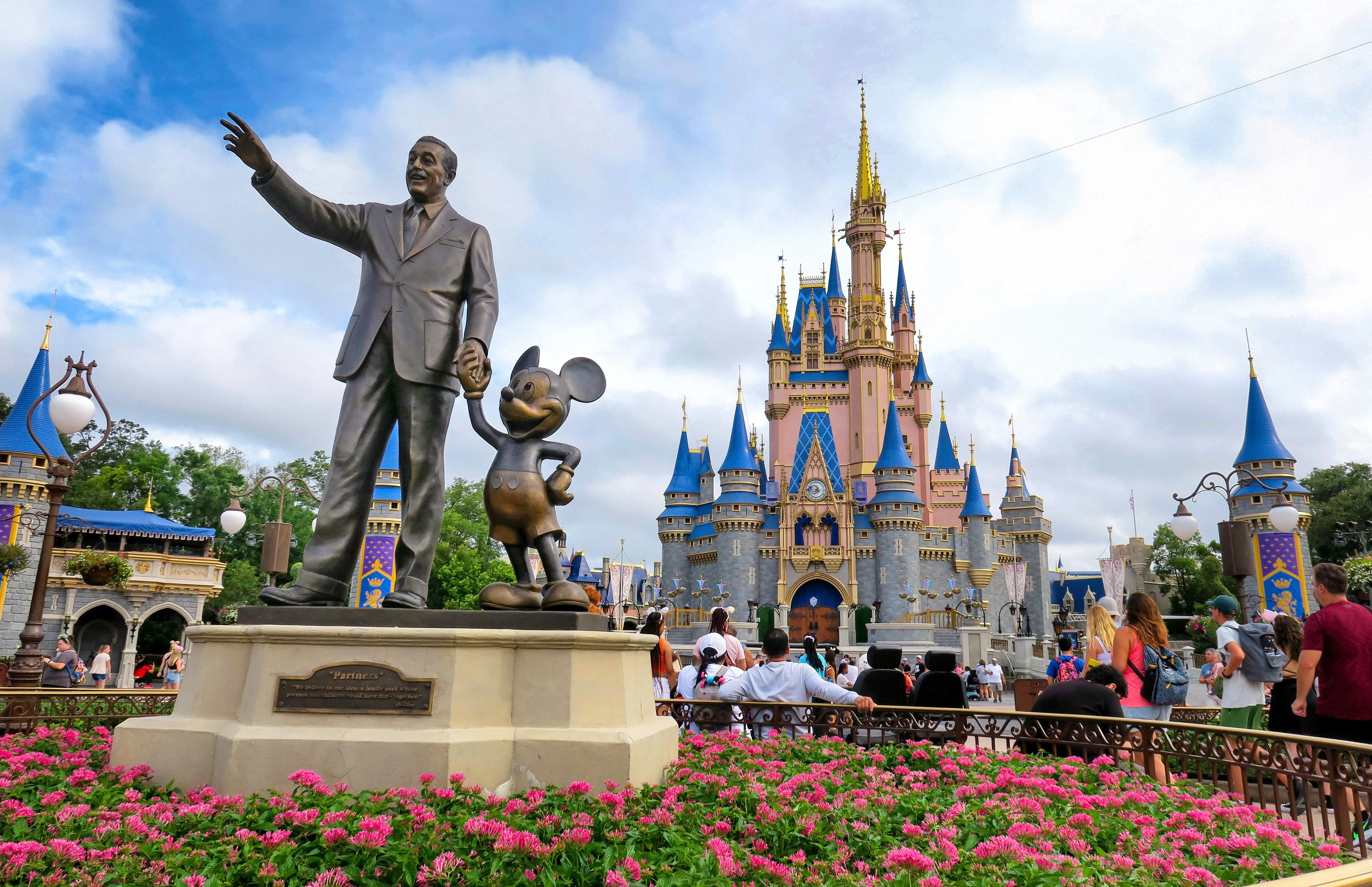 Statue of Walt Disney and Mickey Mouse at Cinderella Castle in Magic Kingdom at Walt Disney World in Florida.