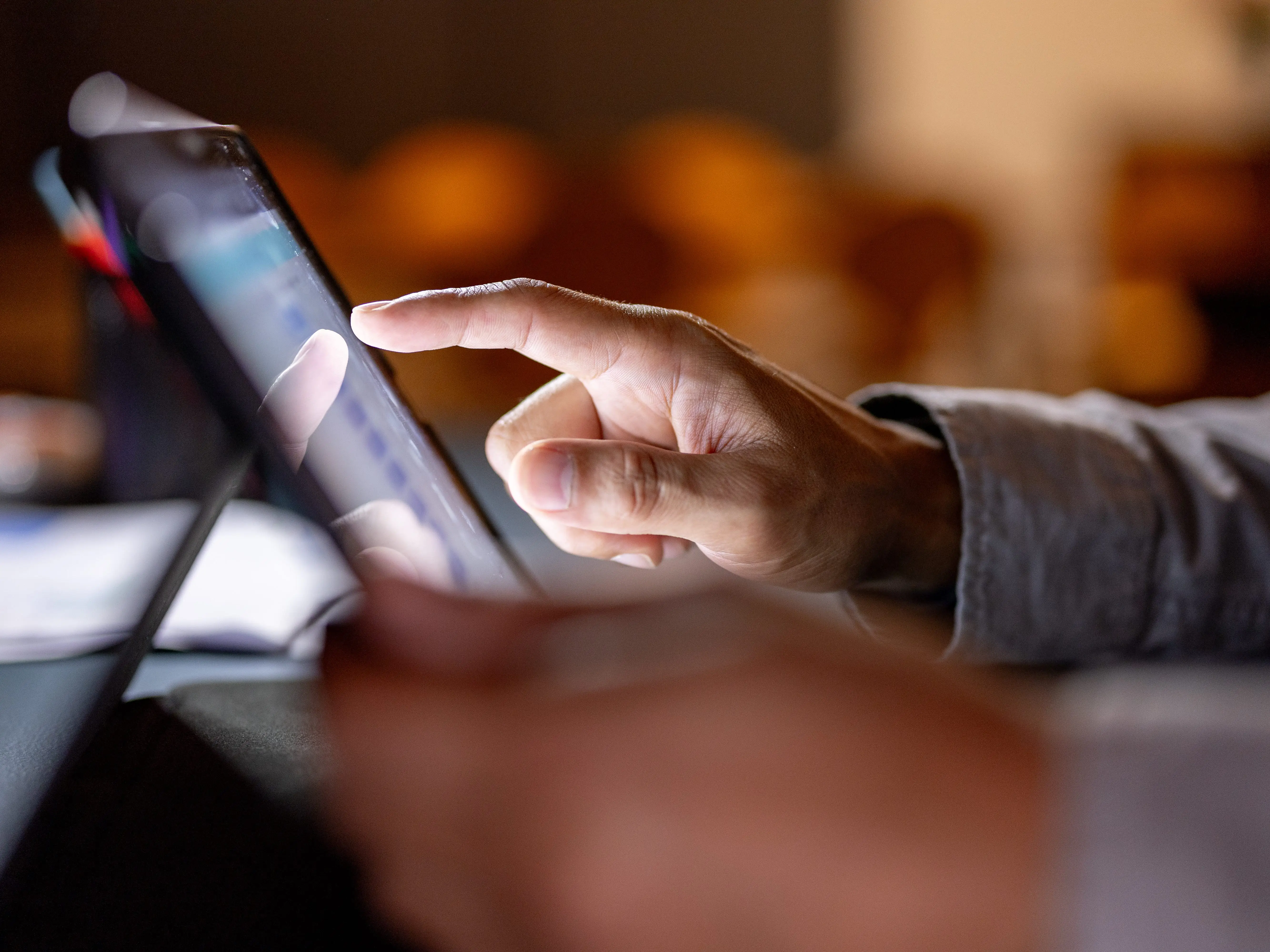 Someone tapping on the screen of a tablet.