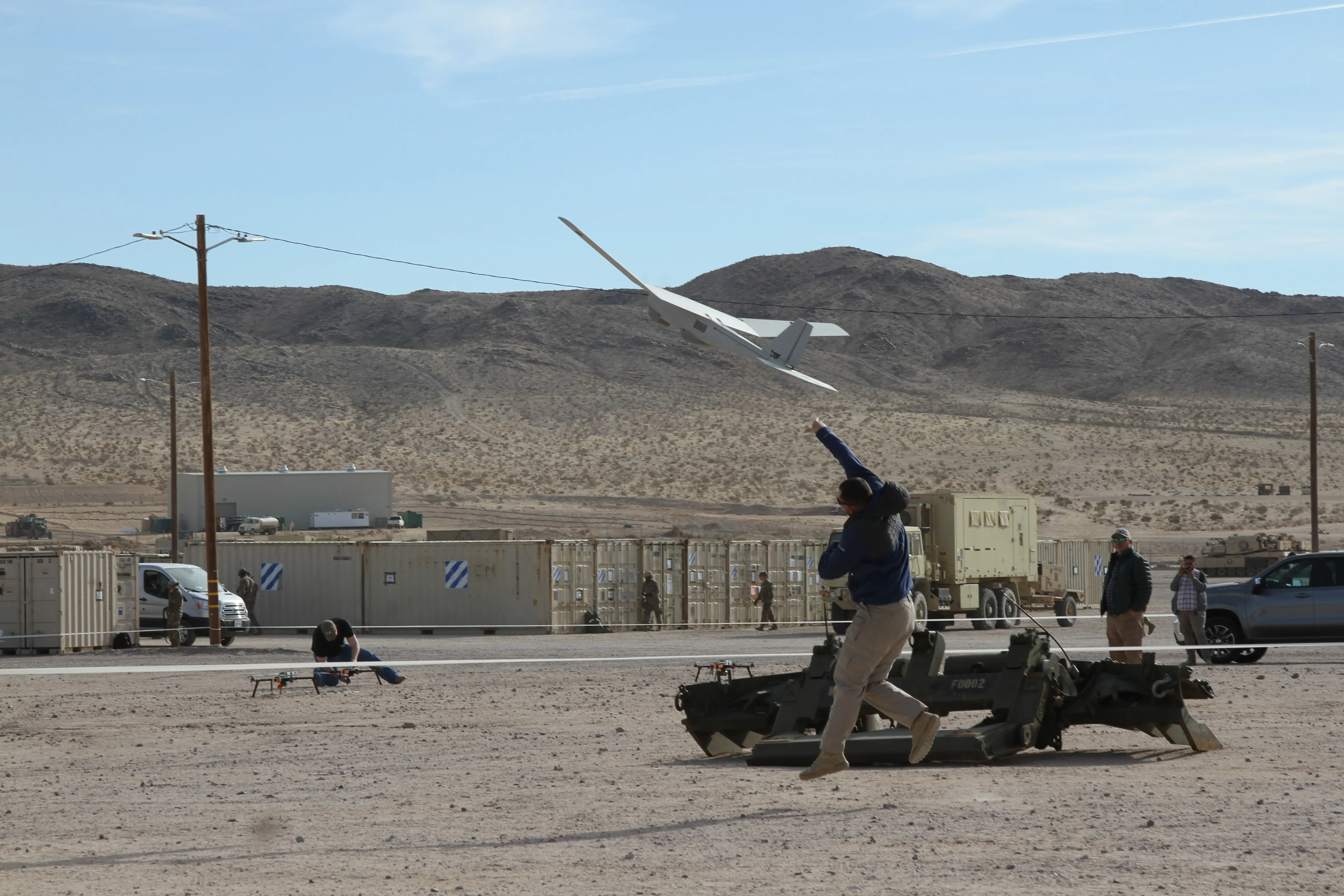 A contractor hand-launches a drone at a counter-UAV training site in California in January 2020.