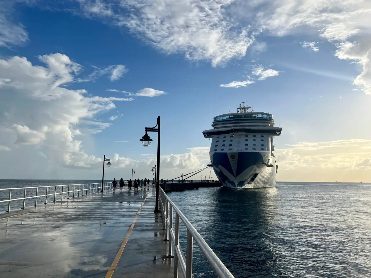 Sky Princess cruise ship docked at the end of a concrete platform.