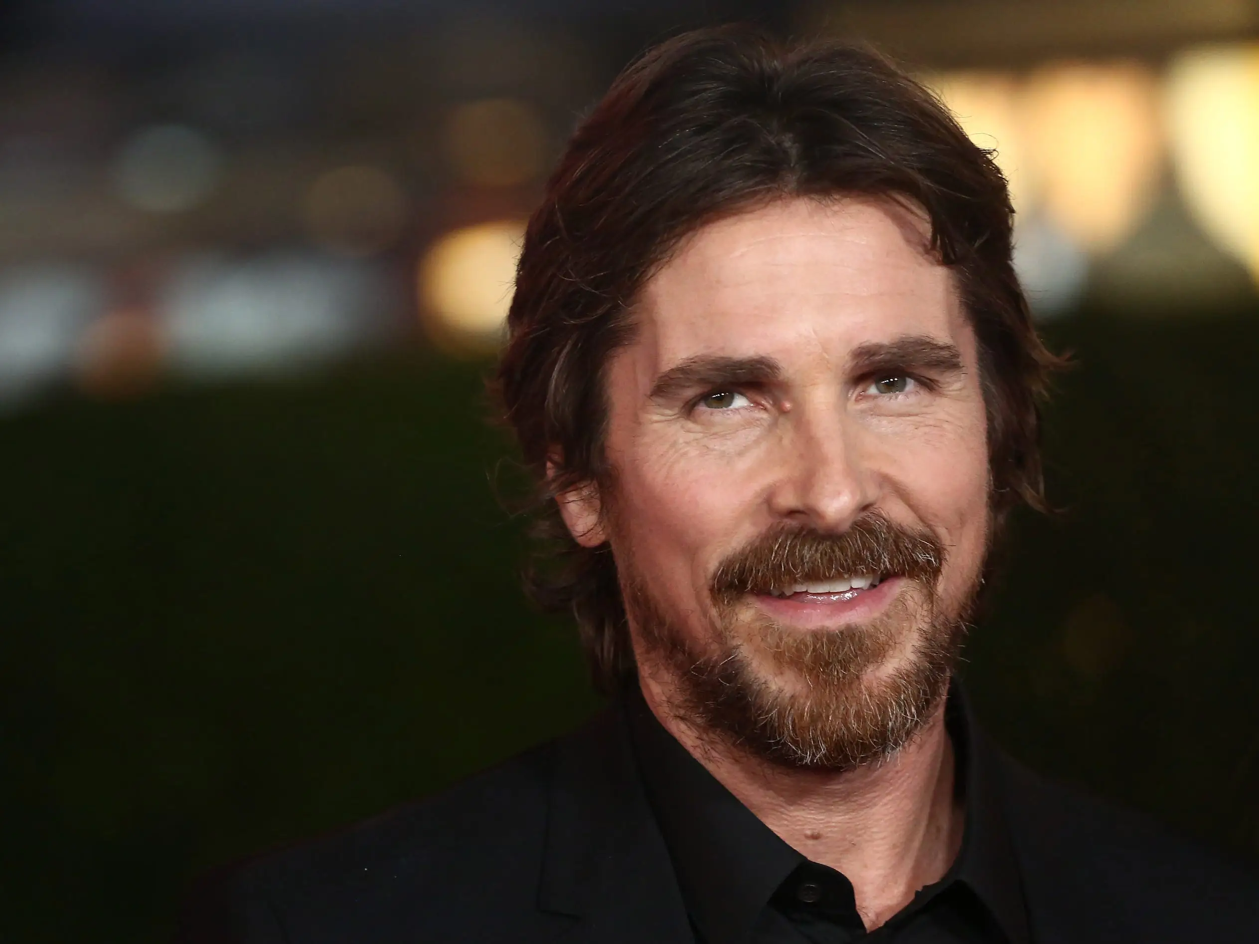 Christian Bale in a black suit