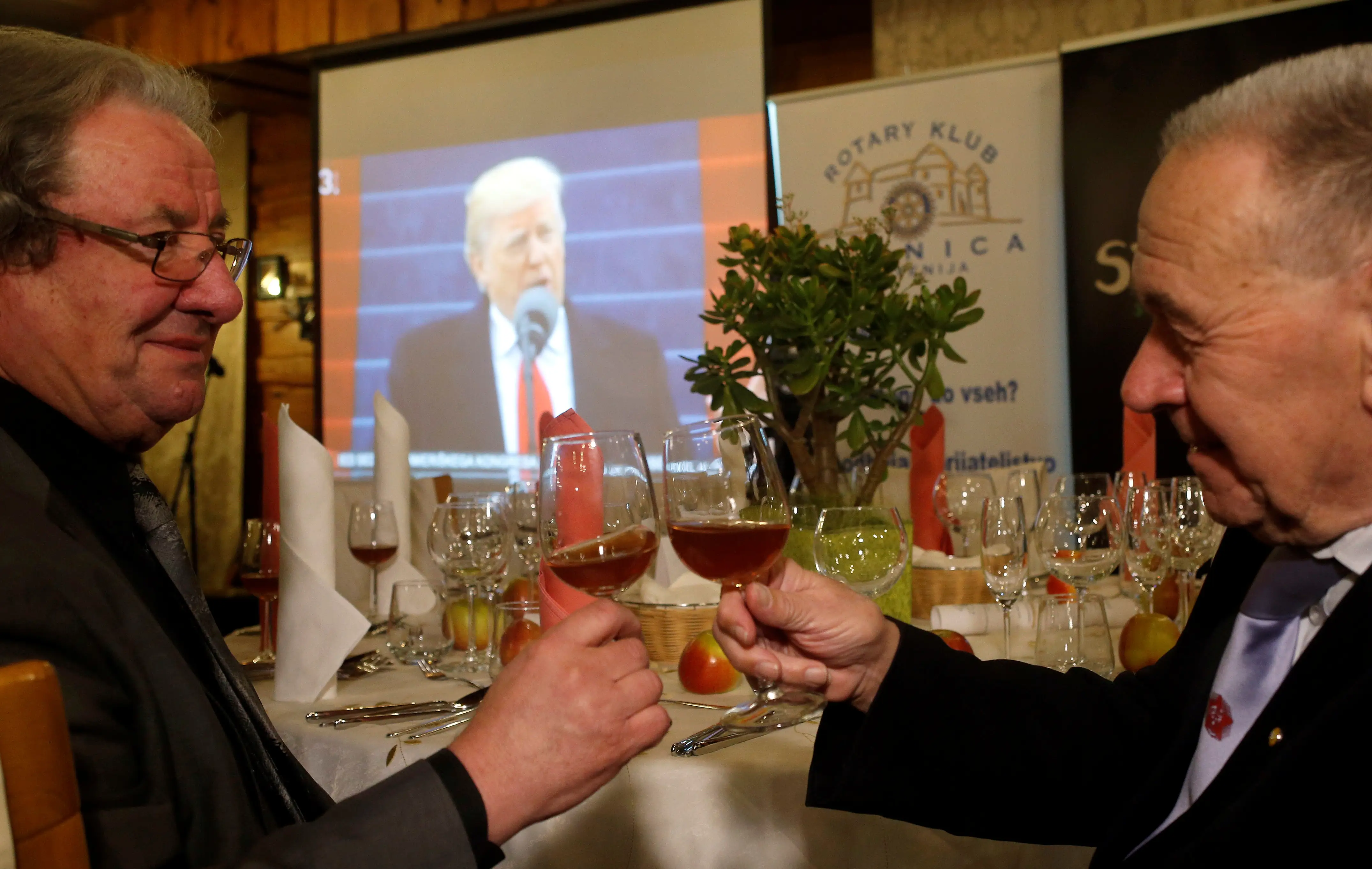 Men toast during the inauguration ceremonies to swear in Donald Trump as the 45th president of the United States, in Melania Trump's hometown of Sevnica