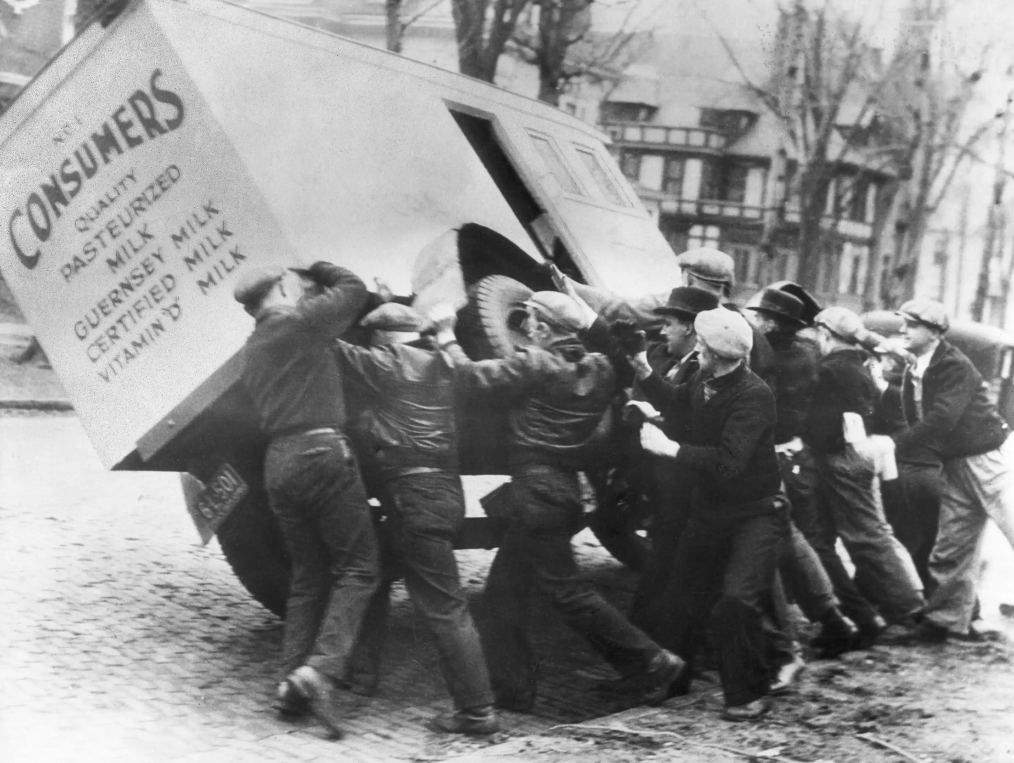 Dairy workers on strike tip over a milk truck in Toledo, Ohio.