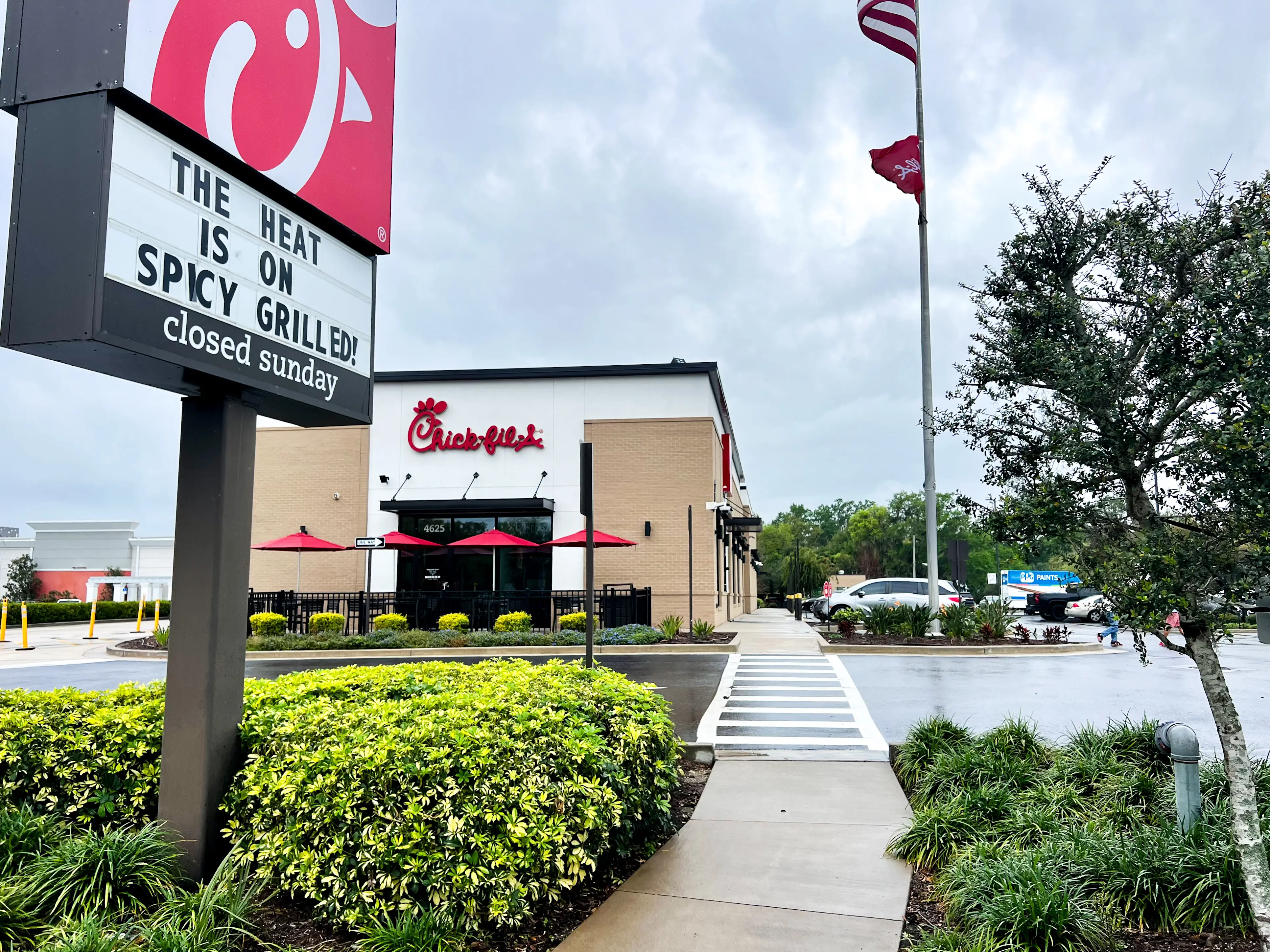 The exterior of a Chick-fil-A restaurant on a cloudy day.