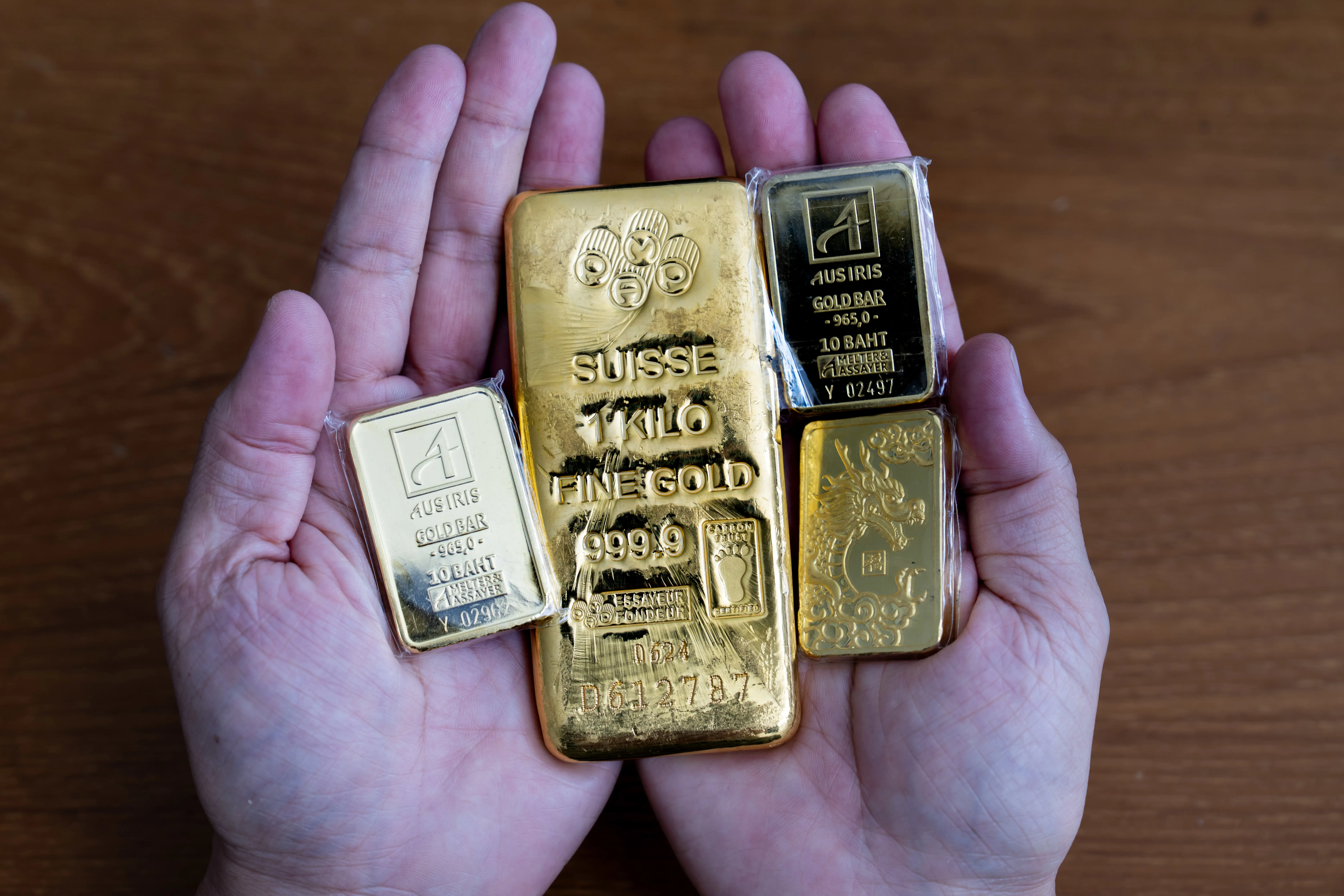An investor holds gold bars in Bangkok, Thailand.